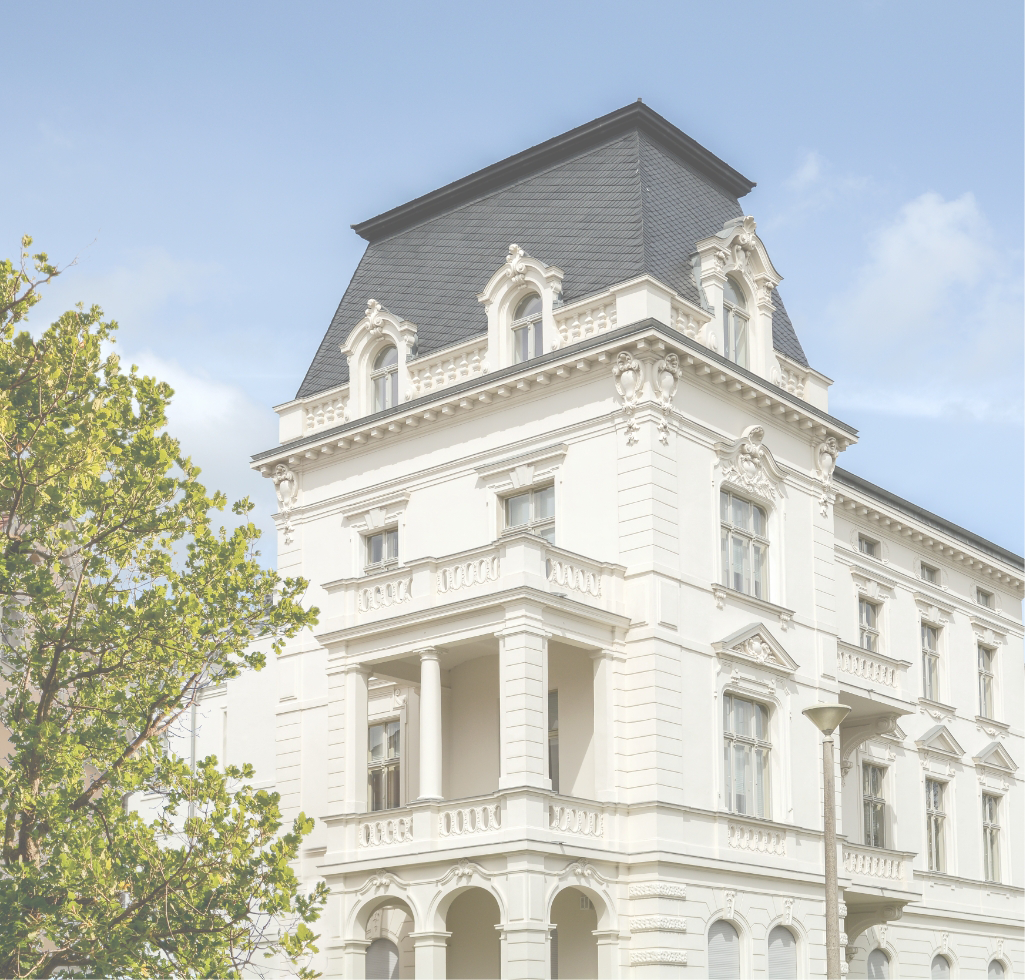 Repräsentatives Altbau-Eckhaus mit klassizistischer Säulenloggia und Mansarddach.